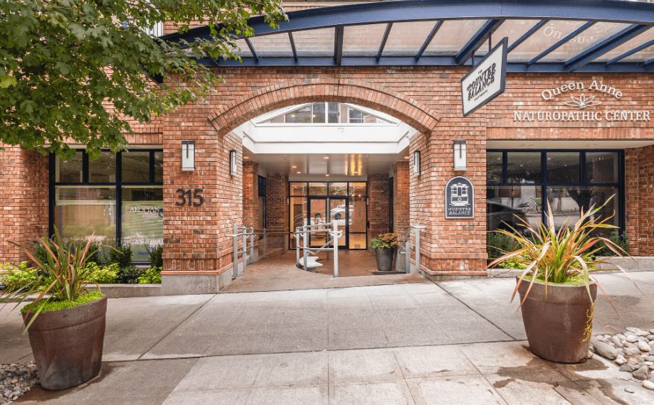 The front of a building with a sign that says "Queen Anne Naturopathic Center".