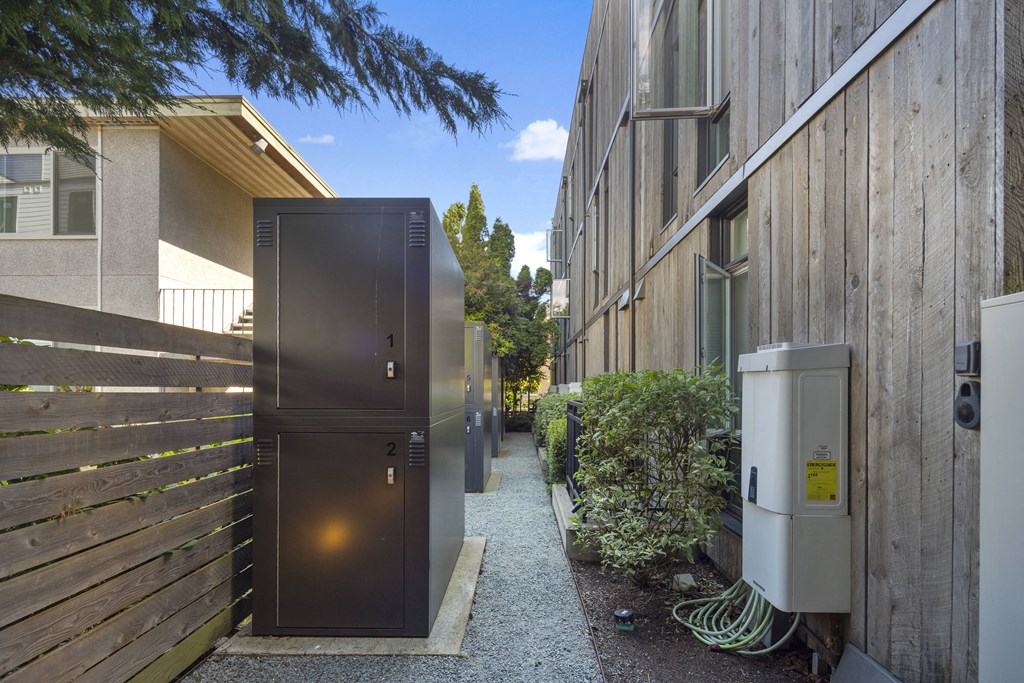 a narrow alley between two buildings with a black door
