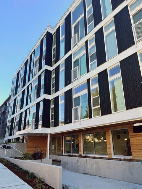an office building with a sidewalk in front of it