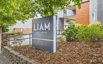 a sign for lamm apartments in front of a building