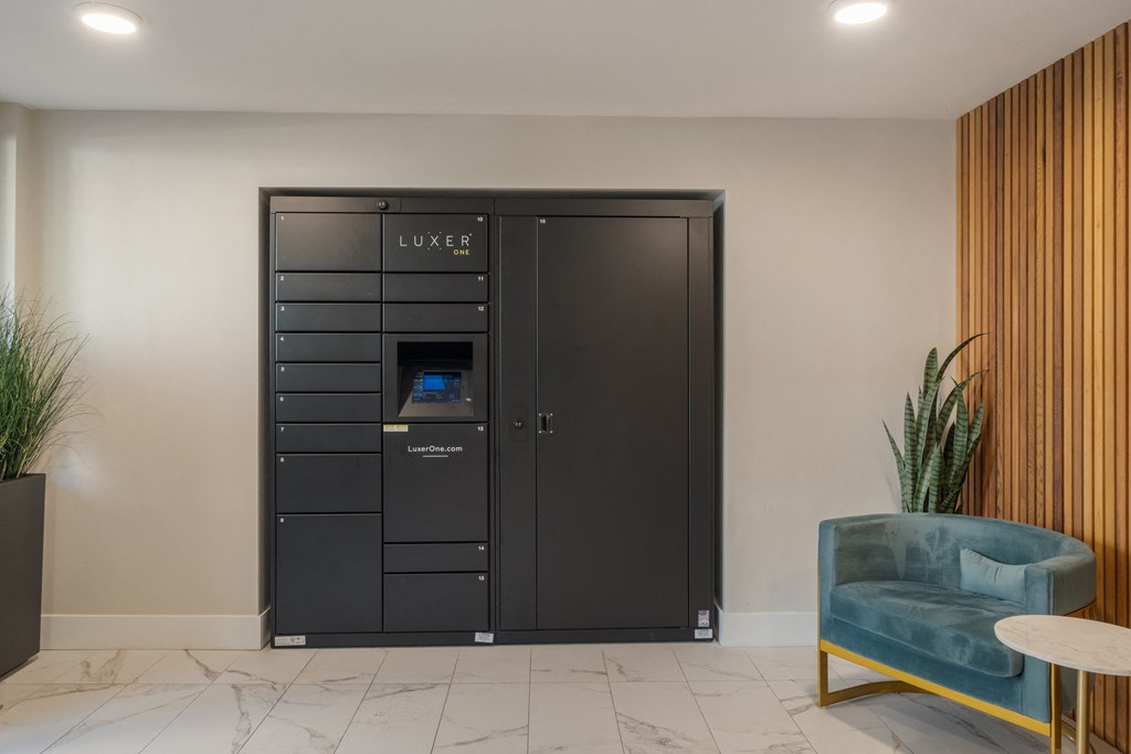 A black LUXER wardrobe with a mirror and a blue chair in front of it.