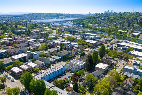 an aerial view of a city with a river and a bridge