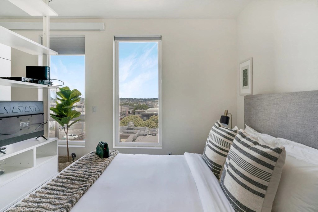 a bedroom with a bed and a window