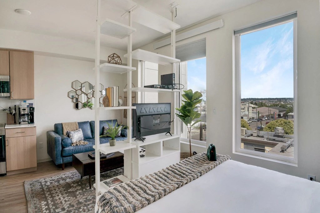 a bedroom with a bed and a large window