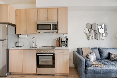 a kitchen and living room with a couch and