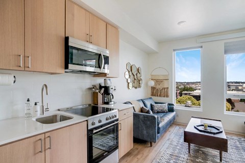 an open kitchen and living room with a view of the city
