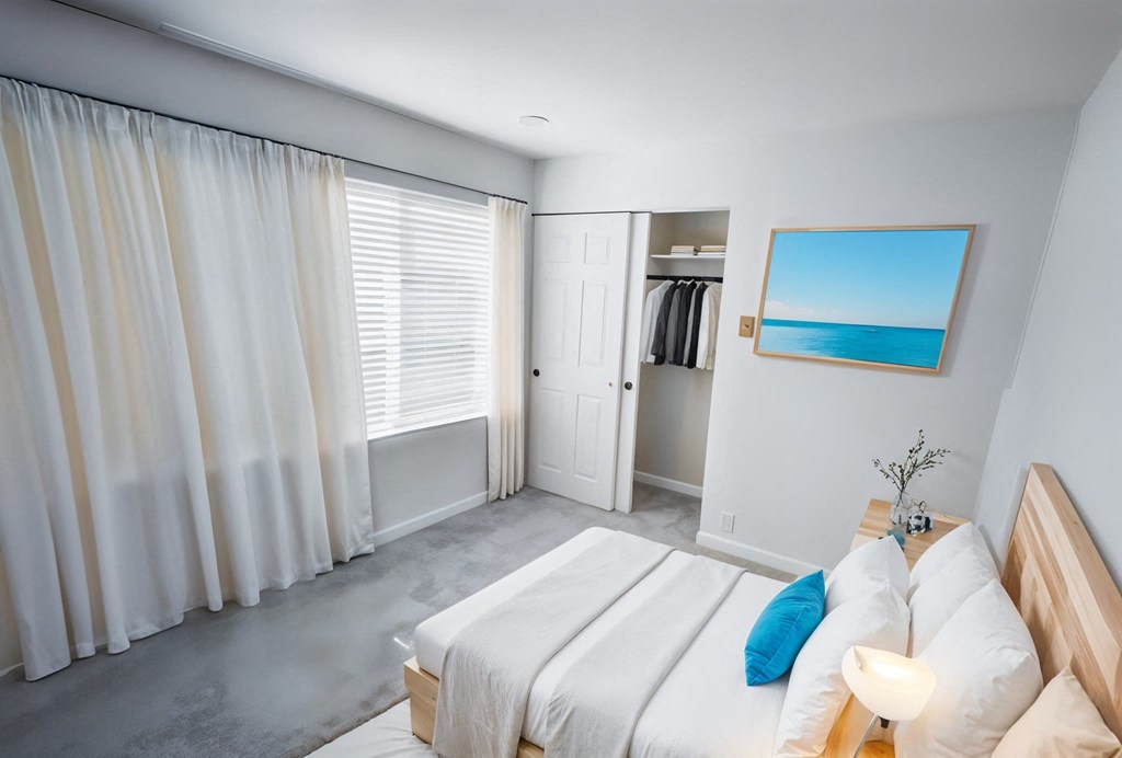 A bedroom with a large bed and a painting of a beach scene on the wall.