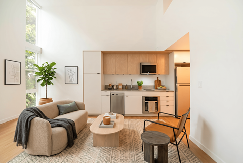 A living room with a couch, chair, and a coffee table.
