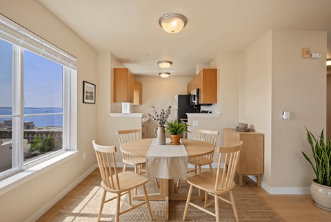 A dining room with a table set for four.
