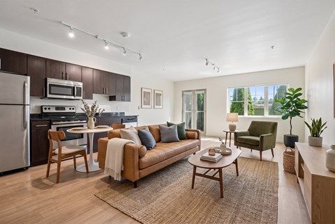 A modern kitchen with a dining table and a couch.