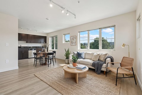 A modern living room with a dining table and chairs.