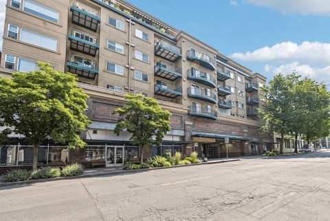 Street view of Hawthorne Apartments, a six-storey building with balconies above ground-floor retail.