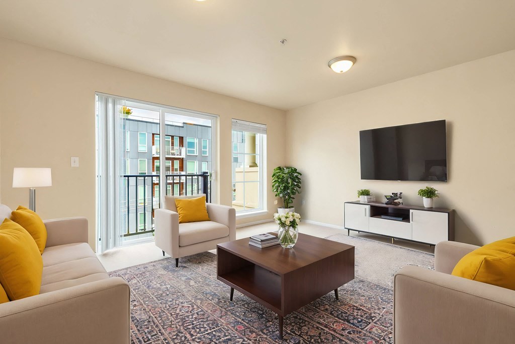 a living room with couches a coffee table and a television