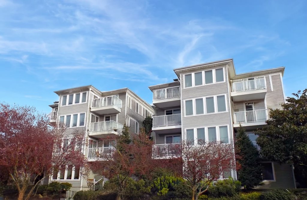 A large, modern apartment building with multiple balconies and windows.