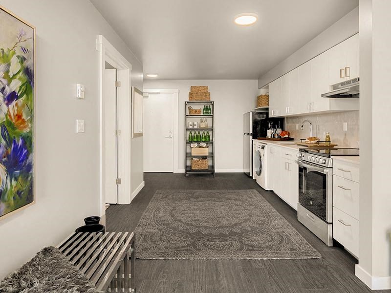 a white kitchen with a stove and a sink