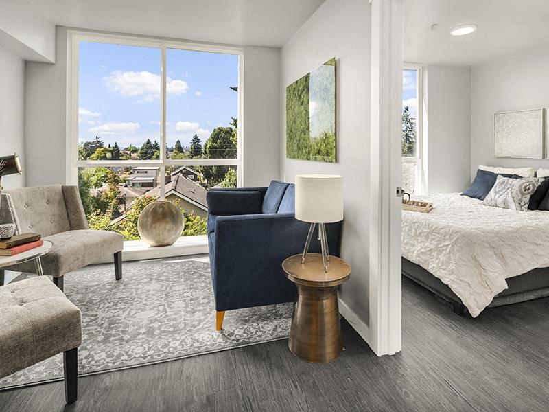 a bedroom with a bed and a large window