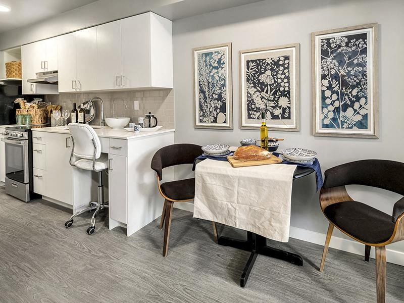 a kitchen and dining room with a table and chairs