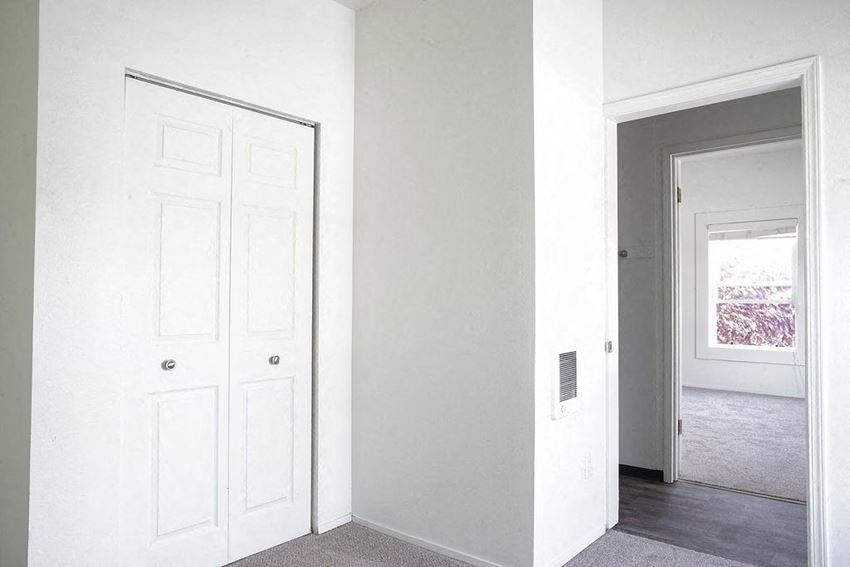 an empty room with a white door and a doorway