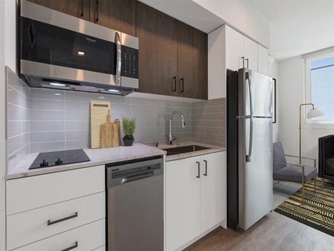 a kitchen with a sink and a refrigerator
