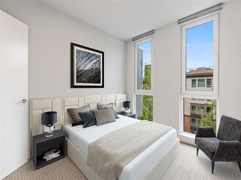 a bedroom with a bed and a large window