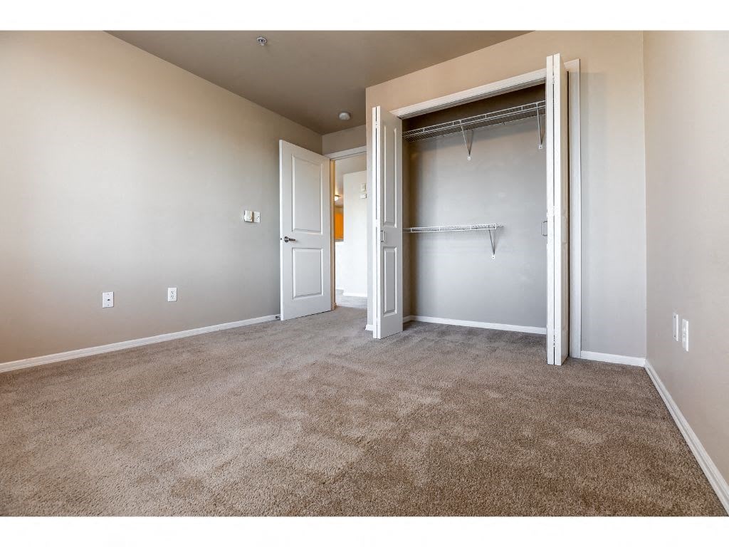 an empty room with a closet and a door