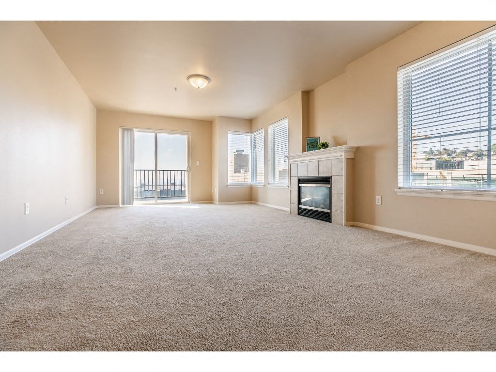 an empty living room with a fireplace