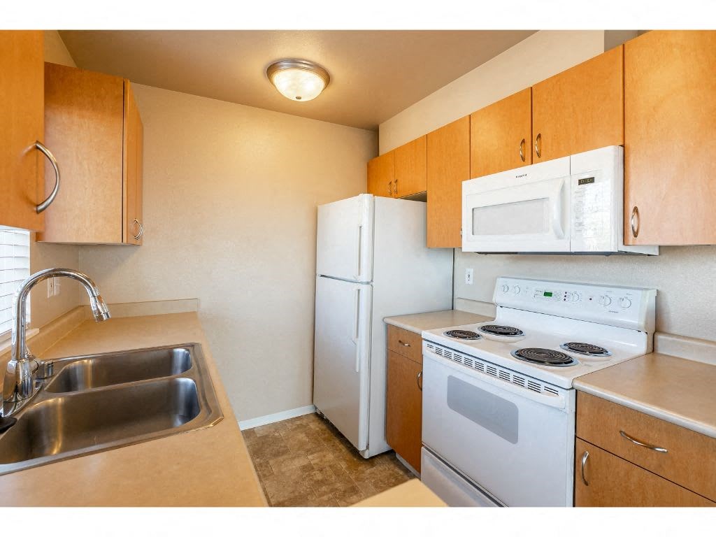 a kitchen with a stove microwave and a sink