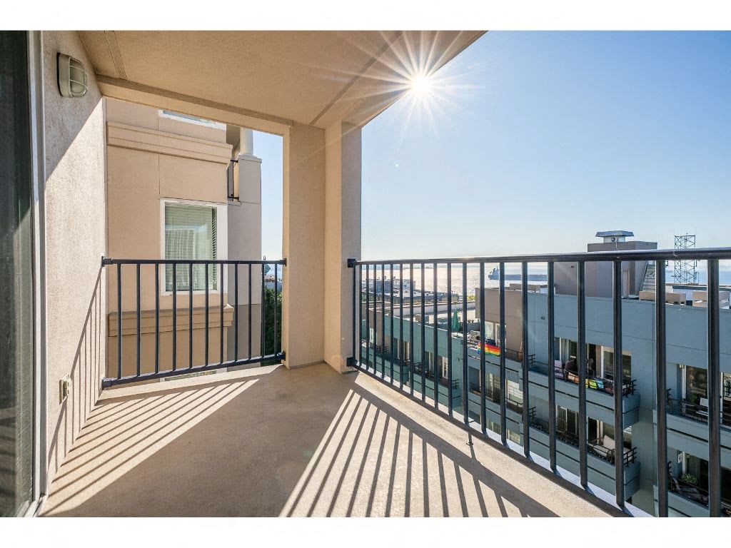 a balcony with a view of the city and a sunny day