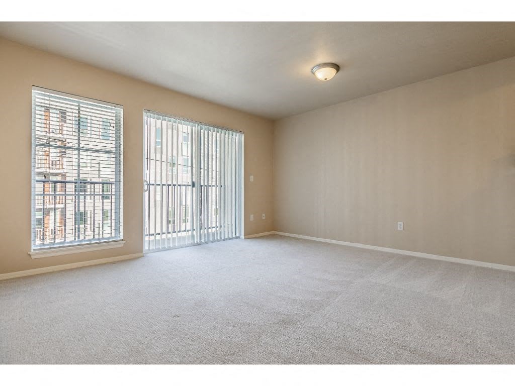 an empty living room with a large window