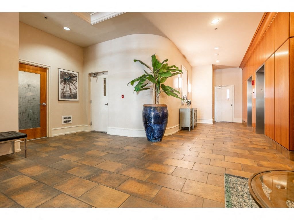 a large lobby with a plant in the middle of the floor