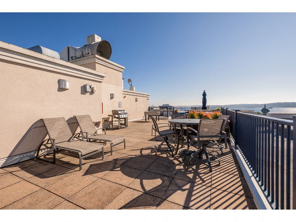 a patio with a table and chairs on a balcony