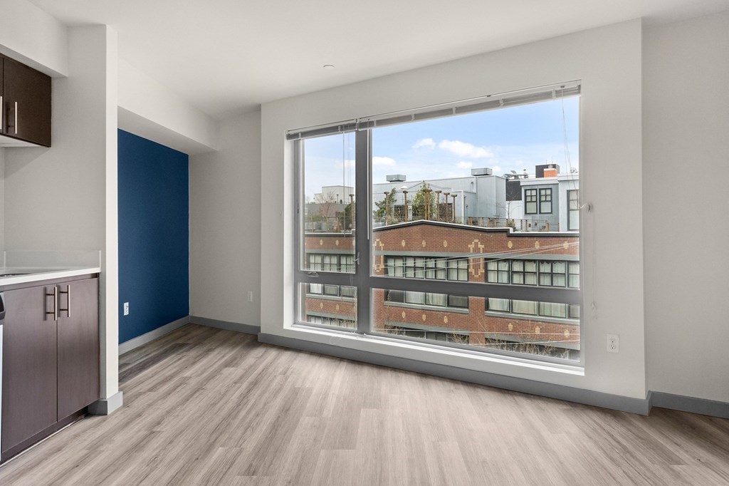 A room with a large window overlooking a cityscape.