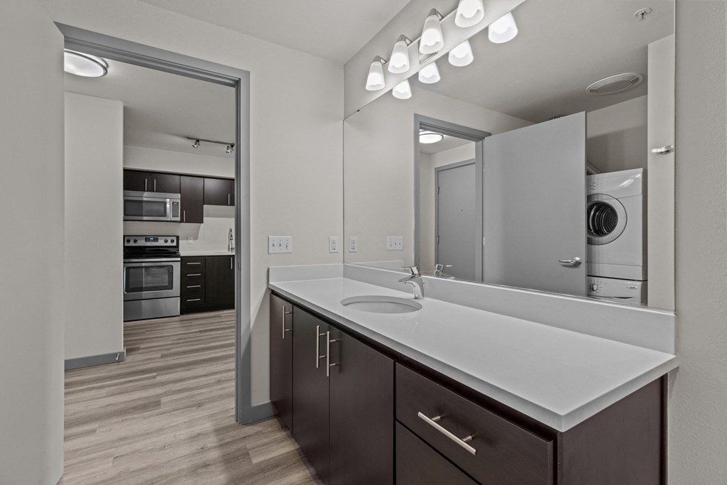 A modern kitchen with dark wood cabinets and white countertops.