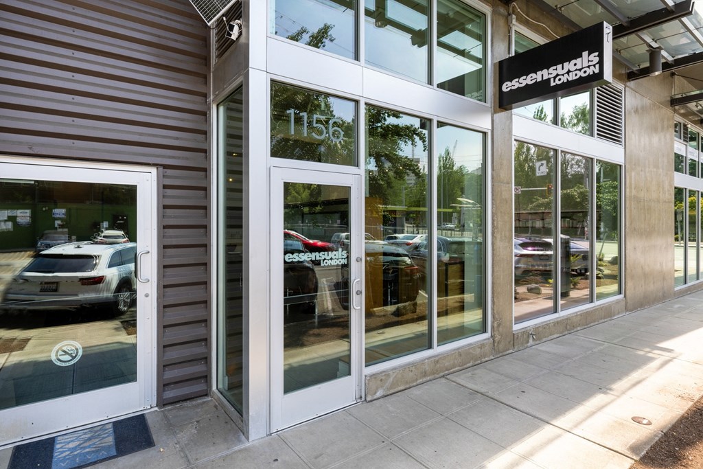 A car dealership with a white car displayed in the window.