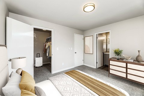A well-lit, modern bedroom with a large bed and a dresser.