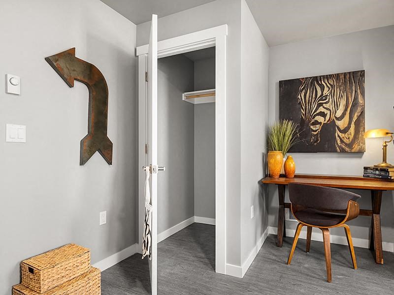 a room with a desk and a painting of a zebra