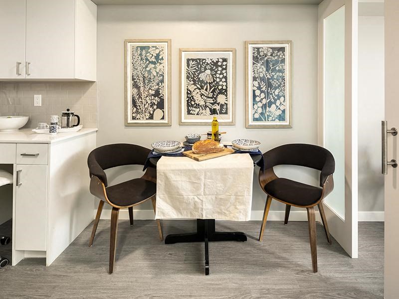 a dining room with a table and two chairs