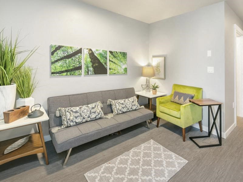 a living room with a couch and a yellow chair