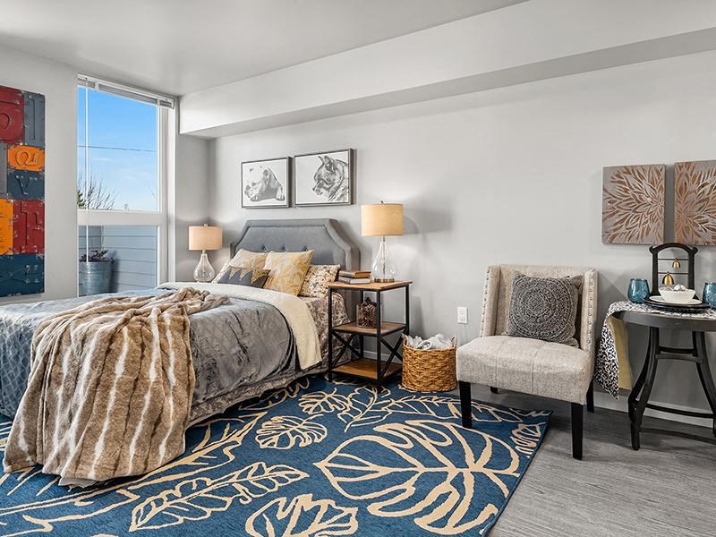 a bedroom with a bed and a chair