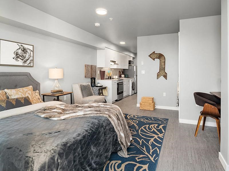 a bedroom with a bed and a living room