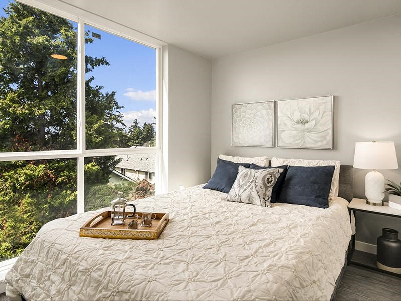 a bedroom with a bed and a large window