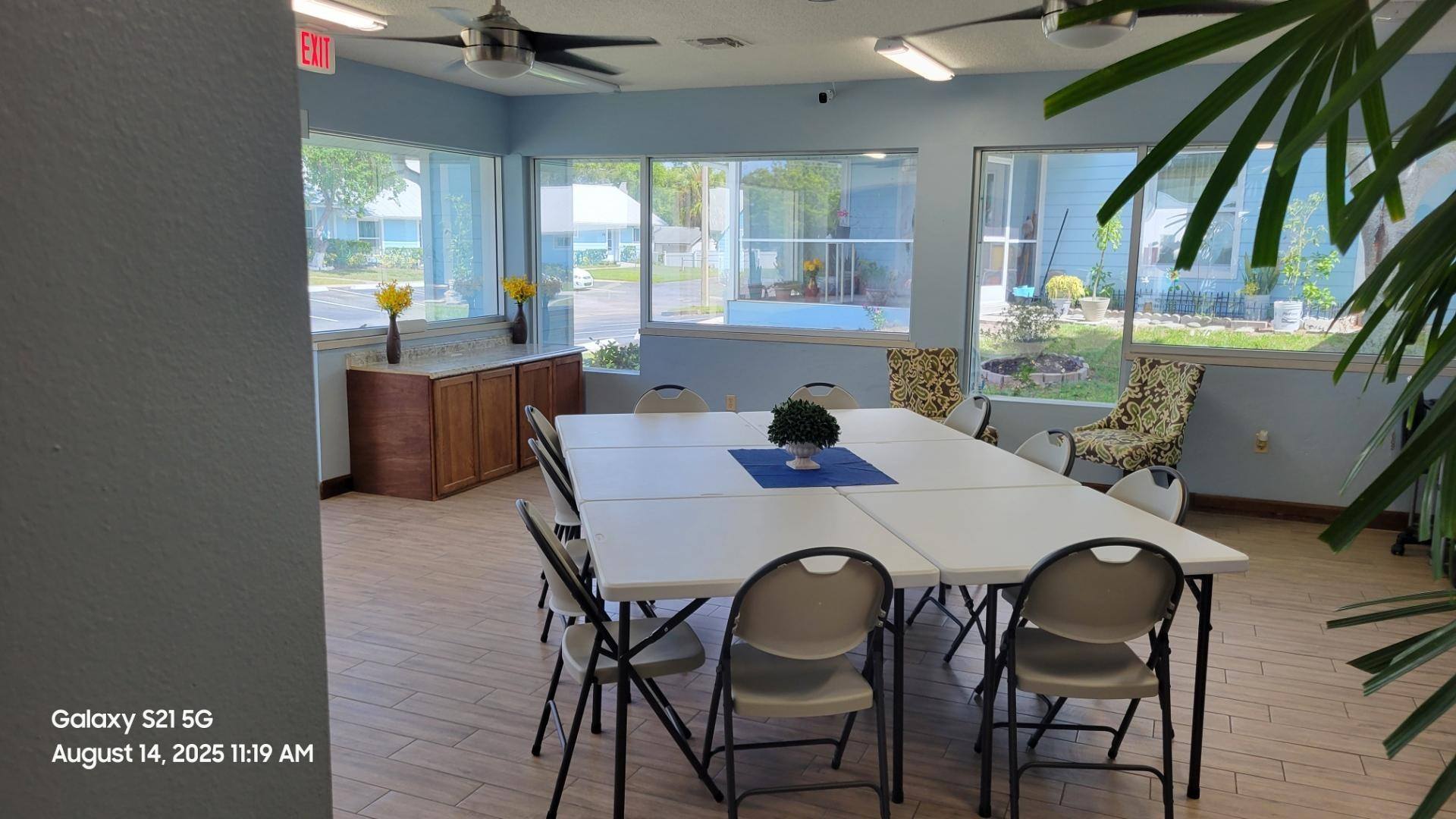 A conference room with a long table and chairs.