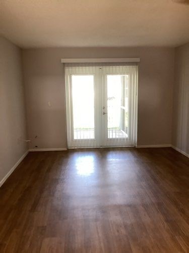 A room with wooden floors and a sliding door.