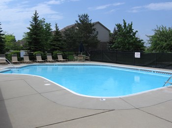 Heated Pool, with plenty of lounge chair sunning, umbrella tables, and shower locker rooms and private restrooms. The Playground and picnic area is located just outside the pool area. - Photo Gallery 5