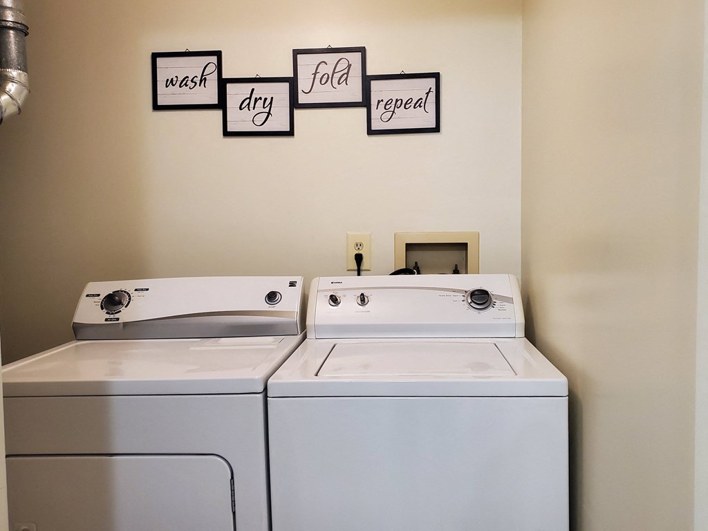 a laundry room with two washes and a dryer