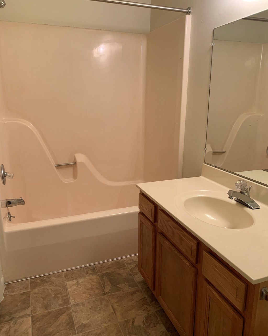 a bathroom with a sink and a tub and a mirror