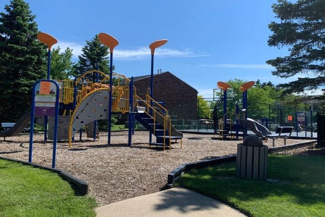 a playground with a bunch of kids playing on it