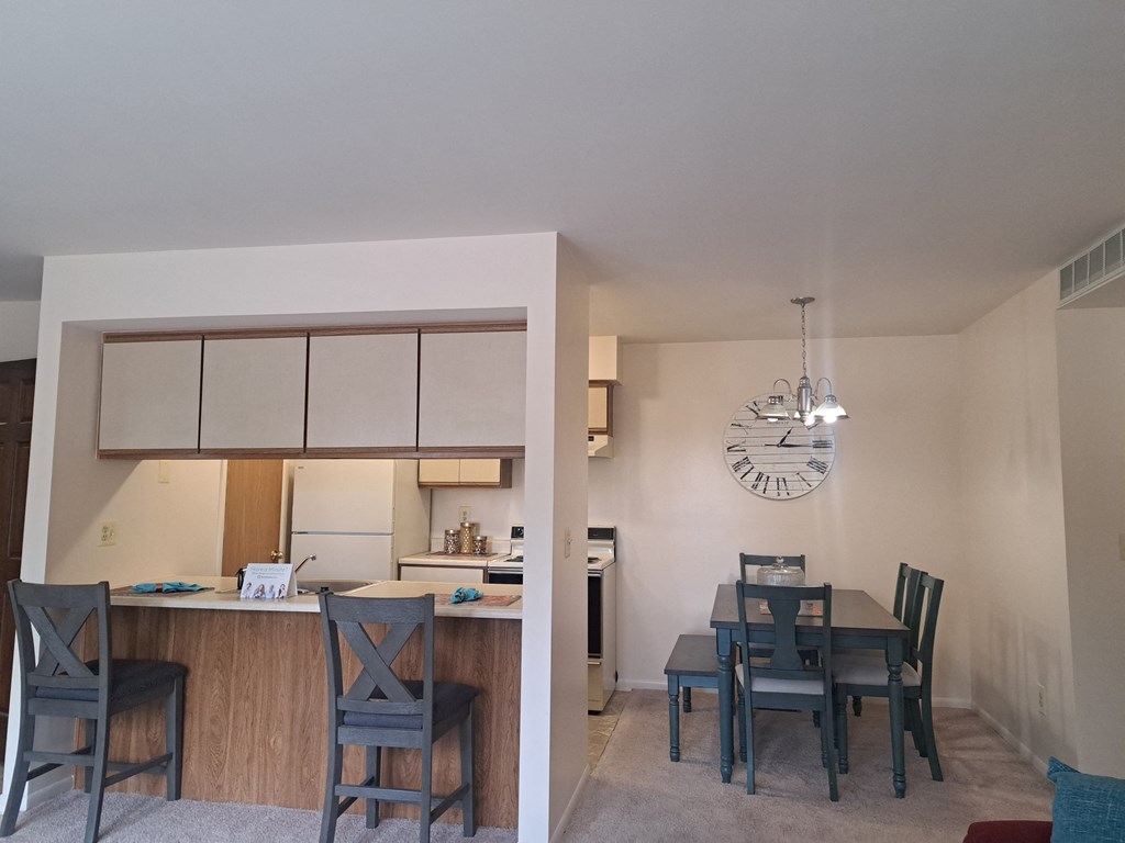 a view of a living room and dining room with a table and chairs and a