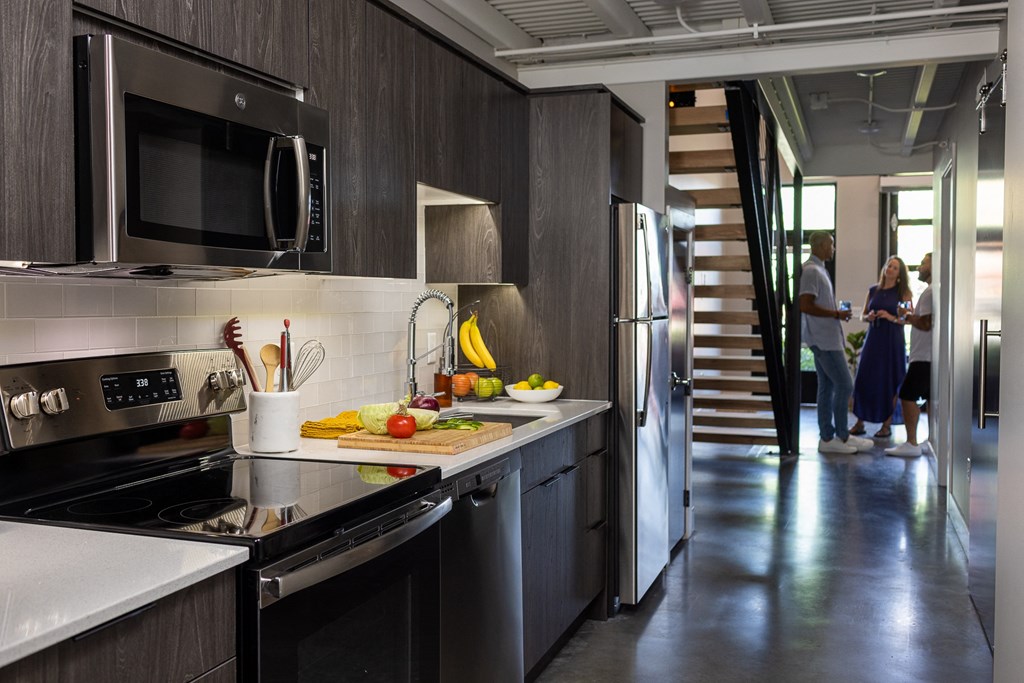 a kitchen with a sink and a stove and a refrigerator