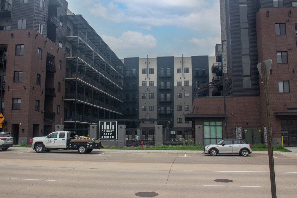 a city street filled with cars and tall buildings